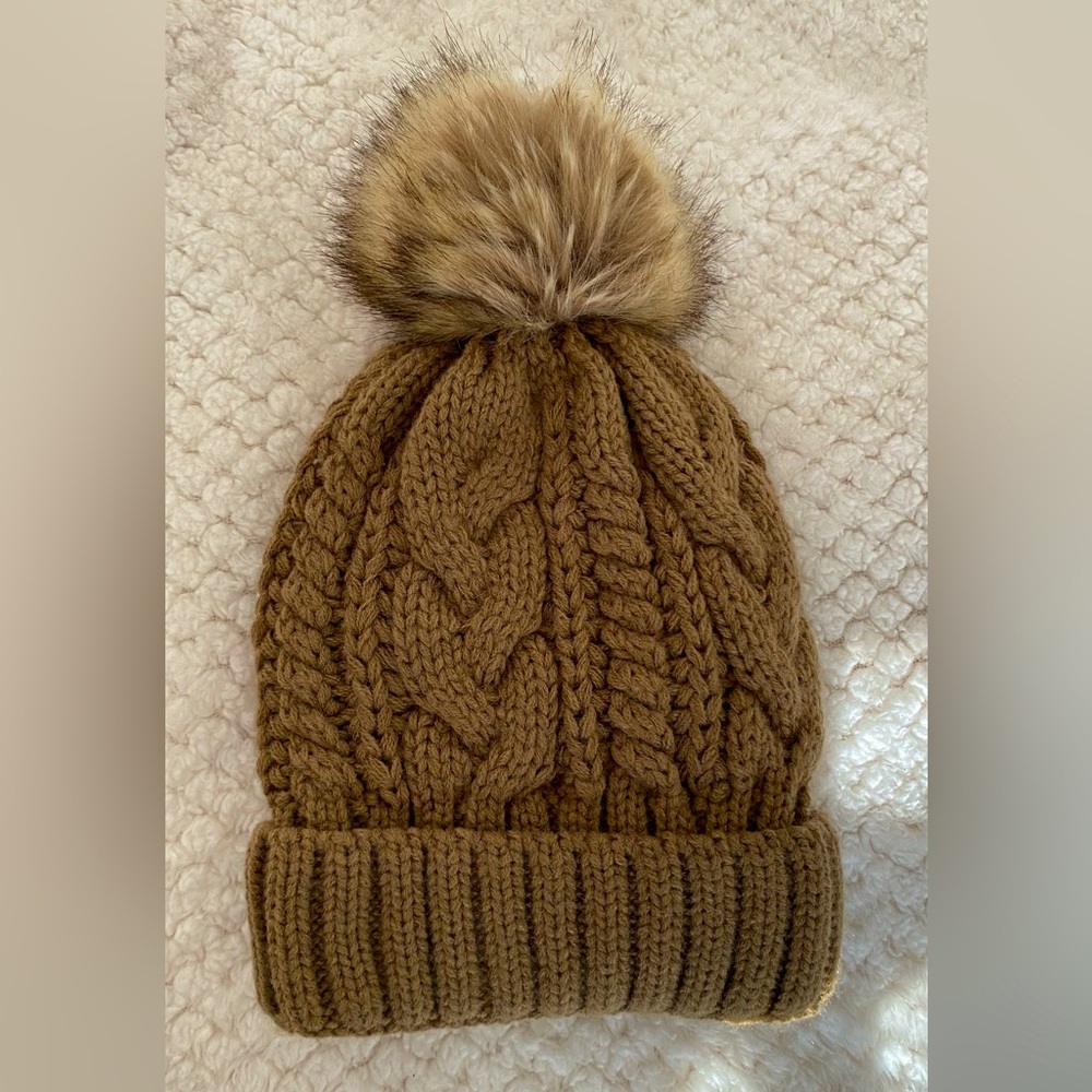 Pure Barre brand winter hat with pom pom. One size, fleece-lined inside